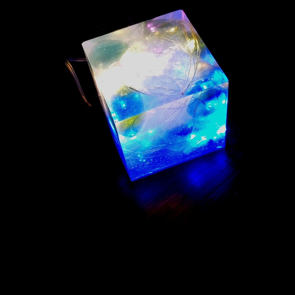 Cube w fairy string lights and glass beads in it epoxy resin